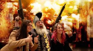 Vermin Supreme files for the Presidential Election with machine guns, flowers and girls on his arms.